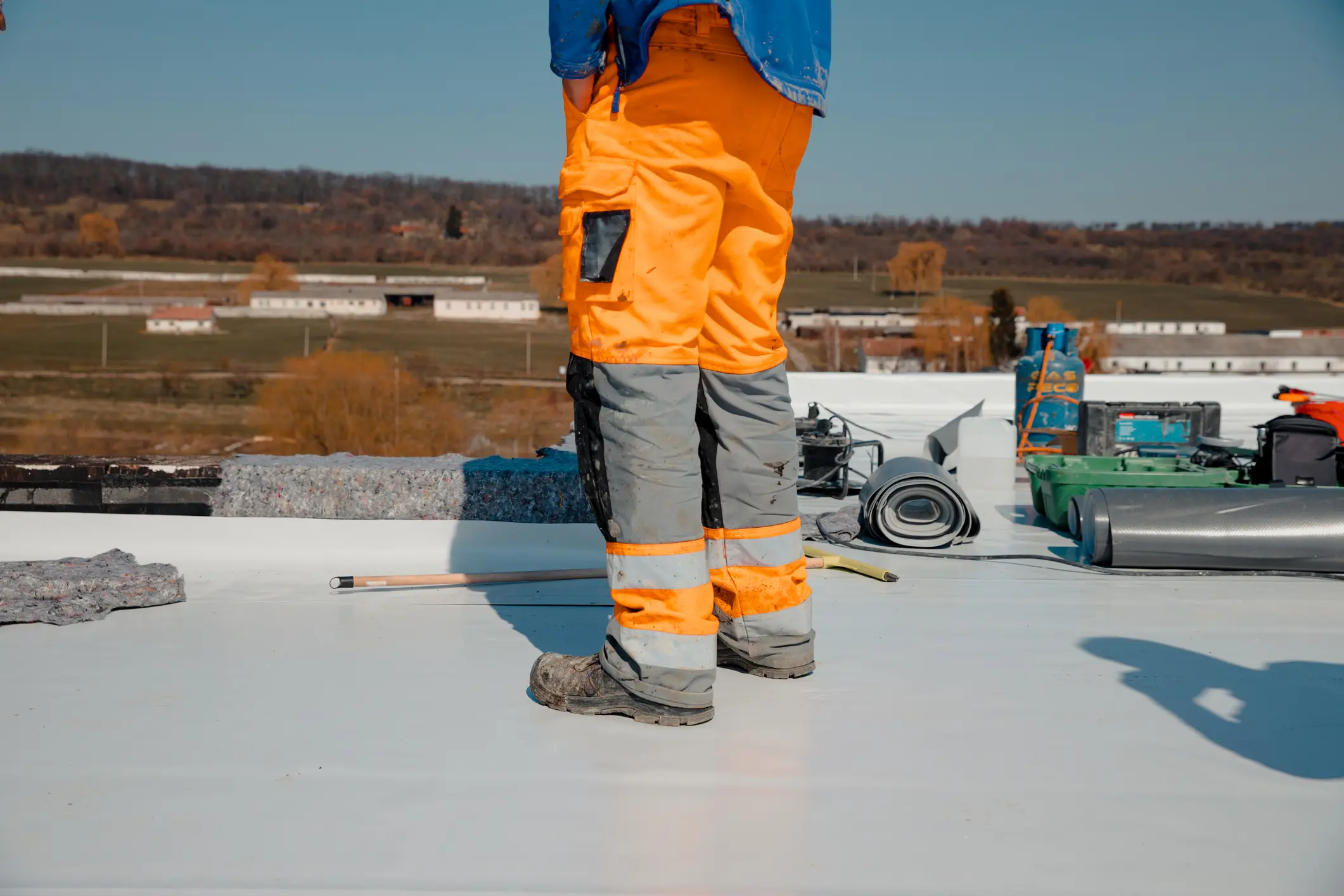 Construction worker on rooftop with tools