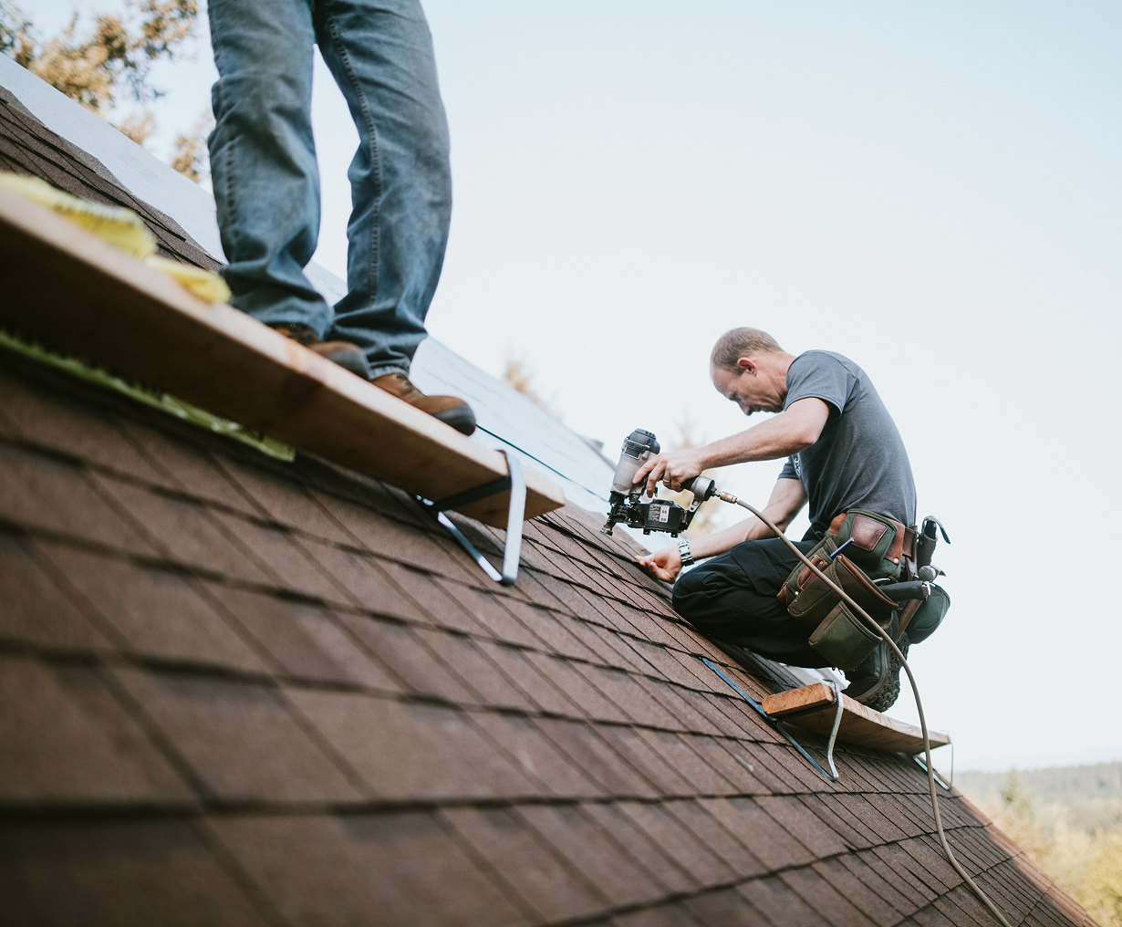 Roofers working on shingle installation