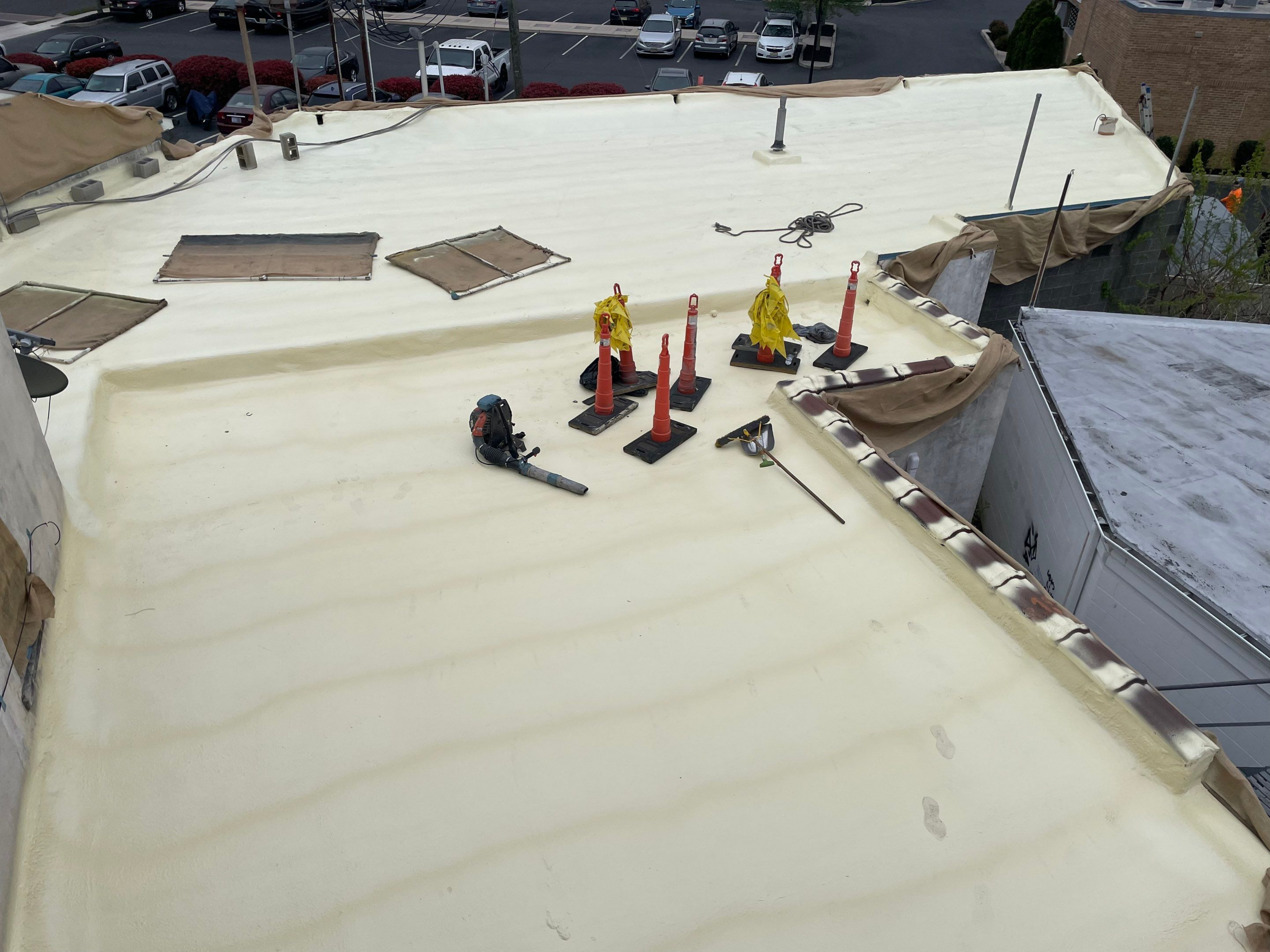 Workers on a large roof preparing for construction or maintenance.