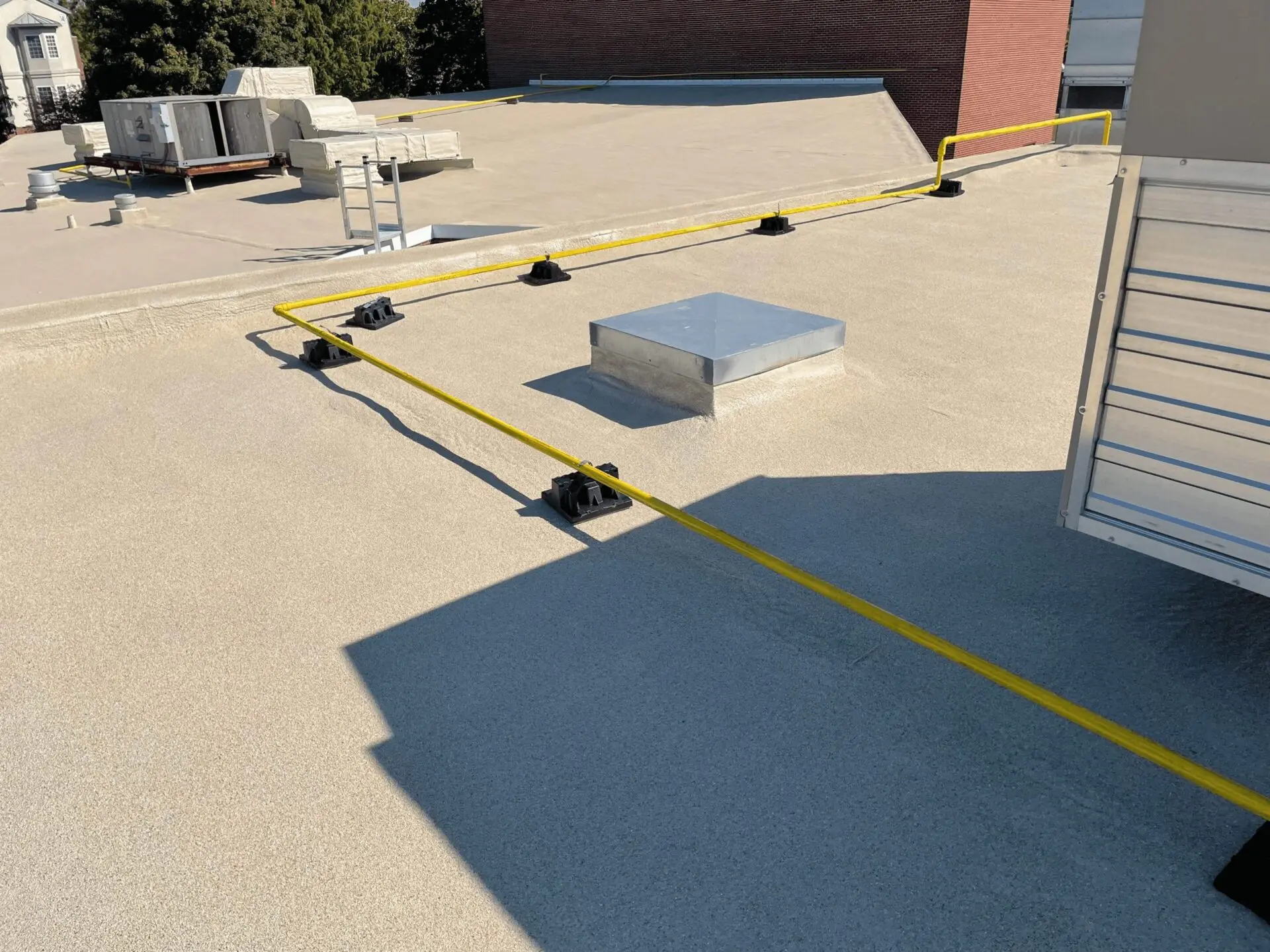 Yellow safety tape cordons off a section on a rooftop.