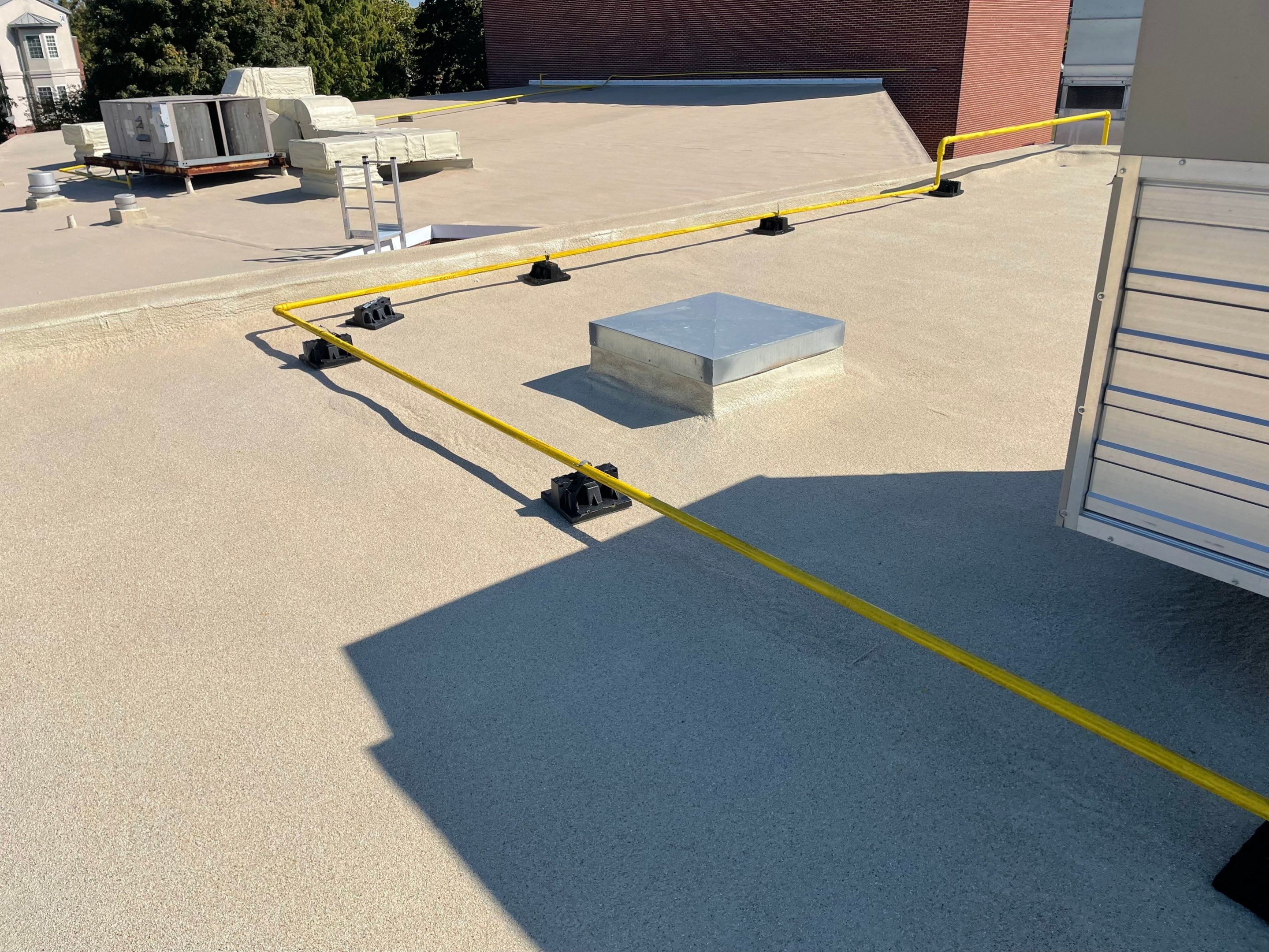 Yellow safety tape cordons off a section on a rooftop.