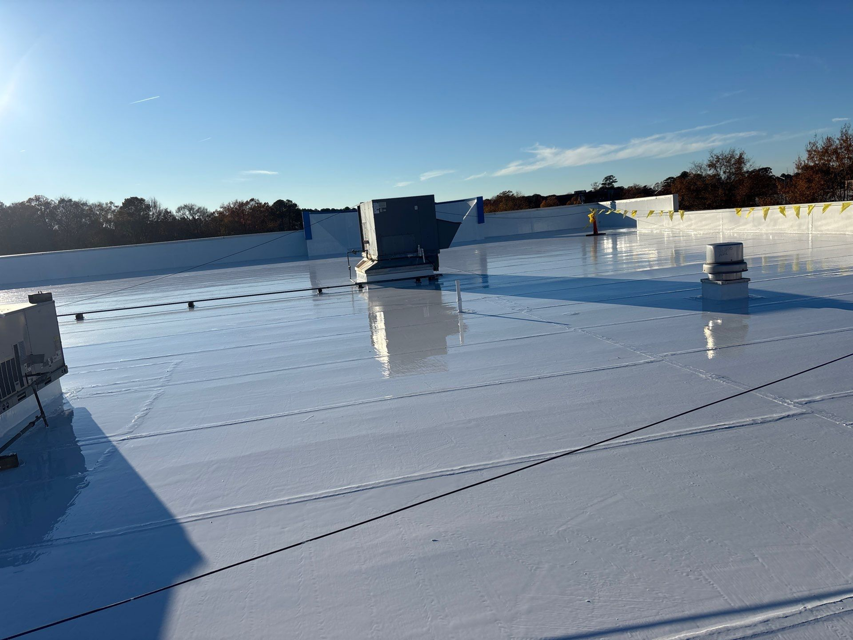 A shiny, reflective rooftop under a clear blue sky.